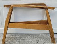 Full view of wooden chair arms and stretcher