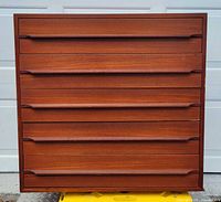 Front view showing five drawers and teak finish