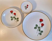 Large, medium and small plates showing Red Rose motif and gold rim