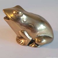 Left side view of solid brass frog figurine
