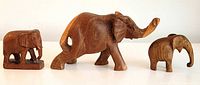 Front view of all three carved wood elephants