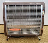 Front view showing grille, brand badge, control buttons and legs
