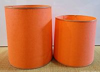 Both orange drum lampshades side by side front view