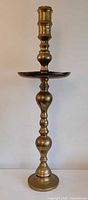 full view of tall brass altar candle stand