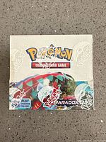 Front of sealed Pokémon TCG Paradox Rift booster box showing artwork and shrink-wrap