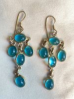 Both earrings laid flat showing cabochon arrangement