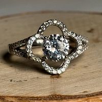 Front view of sterling silver CZ ring on wood disk