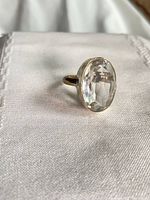 Top view showing oval faceted quartz set in silver ring