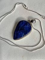 front view of teardrop lapis pendant on chain