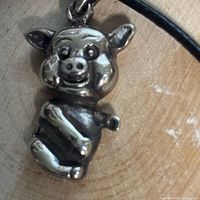 Close-up of sterling silver pig pendant