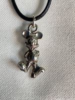 Close view of Mickey Mouse sterling silver pendant on cord
