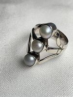 Front angled view showing three pearls and silver setting