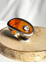 Ring profile on wood slice showing acrylic inset and CZ