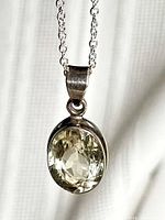 Front close-up of yellow topaz pendant on chain