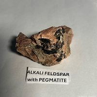 Front view showing pink feldspar matrix and black pegmatite