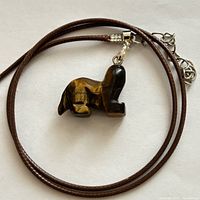 Full view of necklace coiled showing pendant