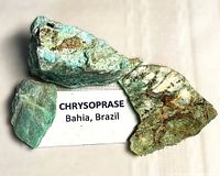 Three rough chrysoprase stones with label Bahia, Brazil