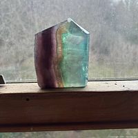 Front view of banded fluorite chunk on windowsill