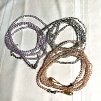 Three crystal bead necklaces coiled by colour