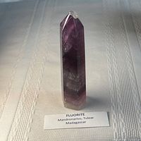 Full view of fluorite tower standing upright showing banded coloration