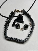 Necklace, bracelet, earrings grouped