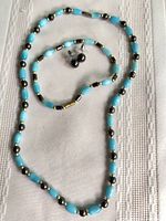 Full view of necklace, bracelet, and earrings laid out showing bead pattern