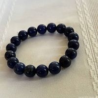 Full view of bracelet formed in circle on fabric surface