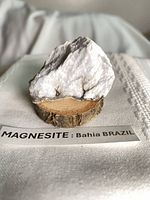 Front view of magnesite on wood base with label
