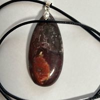 Full view of teardrop agate pendant on cord