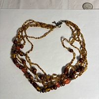 Full view of multi-strand beaded necklace laid flat