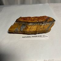 Top view showing chatoyant brown-gold surface and Brazil label