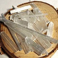 Close-up of satin spar gypsum fragments on wood slice