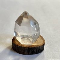 front view of quartz point on wood slice