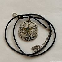 Full necklace coiled showing pendant, clasp and extension