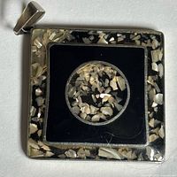 Front view of square silvertone pendant with shell-infused resin inlay