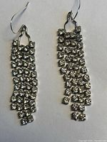 Front view of both earrings showing cascading CZ rows and ear wires