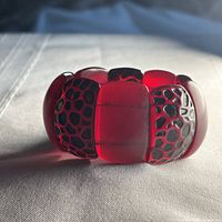 Top view of mauve lucite stretch bracelet showing alternating patterned panels