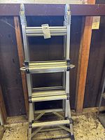 ladder folded upright front view showing steps and hinges