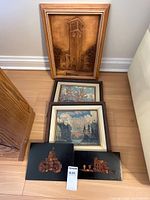 All five artworks grouped: wood relief, two framed prints, two amber mosaics