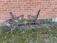 Bench side frames, decorative panel, stool frame against brick wall