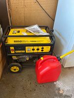 Front view of Champion generator showing frame, wheels, gas can and manual on top