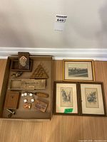 Overall lot view showing framed prints and tray of small collectibles