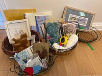 Overall lot with craft supplies, two framed artworks, multiple wicker and wire baskets