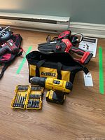 Overall lot: DeWalt drill with bit set and Benchmark chainsaw with accessories