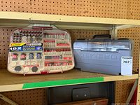 Alltrade 182-piece accessory kit next to closed Dremel case
