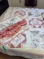 Quilt laid on bed with both pillow shams
