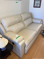 Front view of cream leather La-Z-Boy reclining sofa