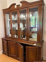 Full view of china cabinet showing crown top, glass doors, wood lower section