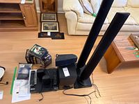 Overhead view of all components: player, speakers, remotes, manuals, DVDs