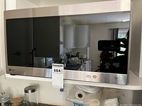 Front view of LG stainless steel Smart Inverter microwave on shelf